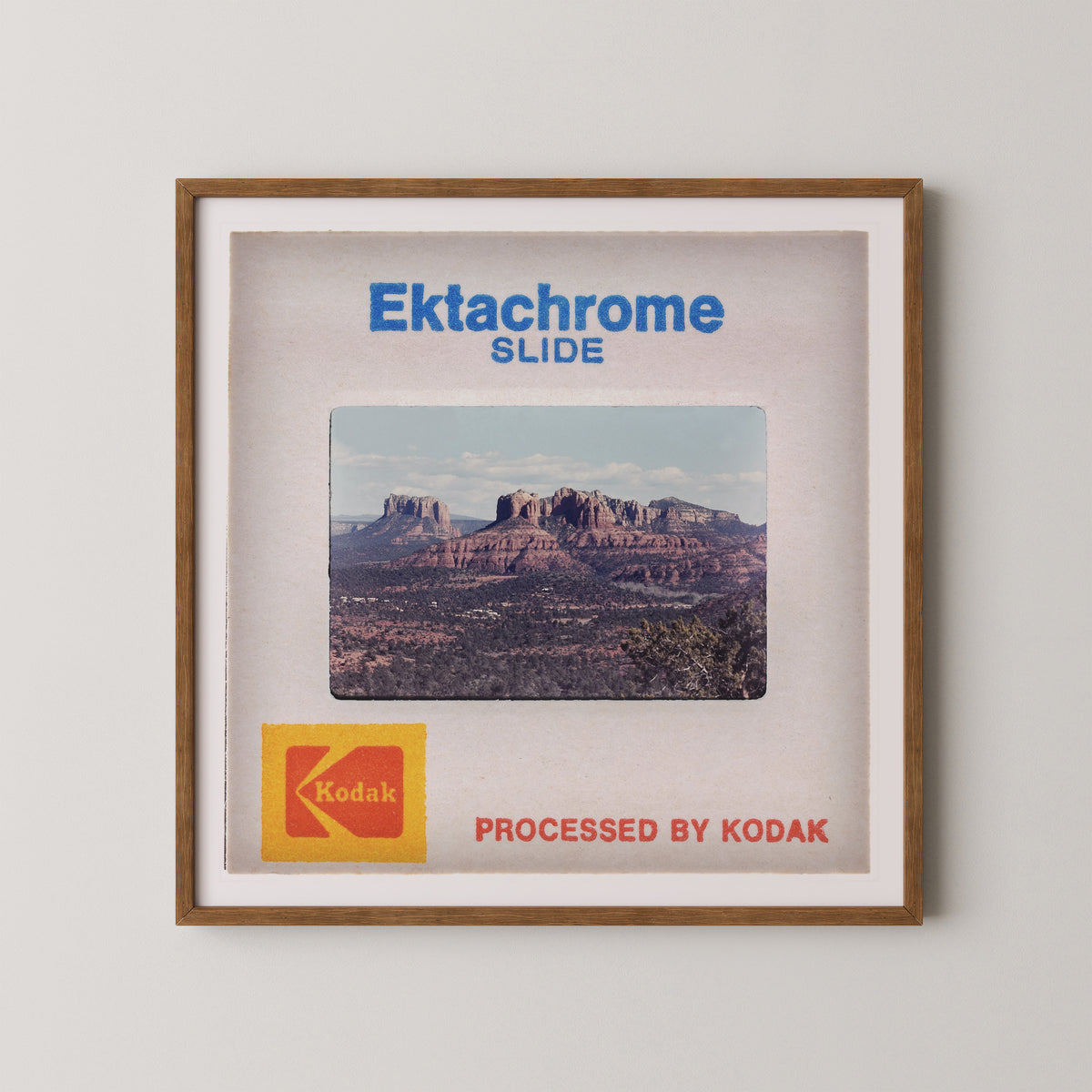 The image is a framed slide from a Kodak slide projector, featuring a scenic desert landscape with mountains in the background.