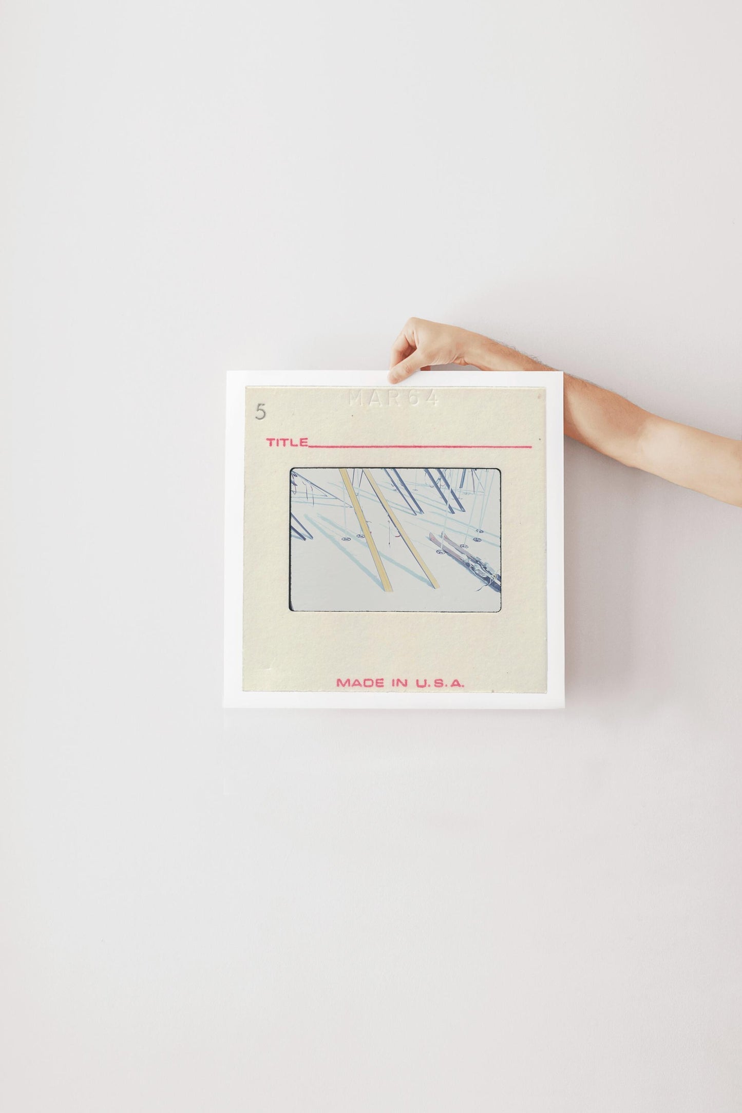 A person's hand is holding a framed image with a title and the text "MADE IN U.S.A."