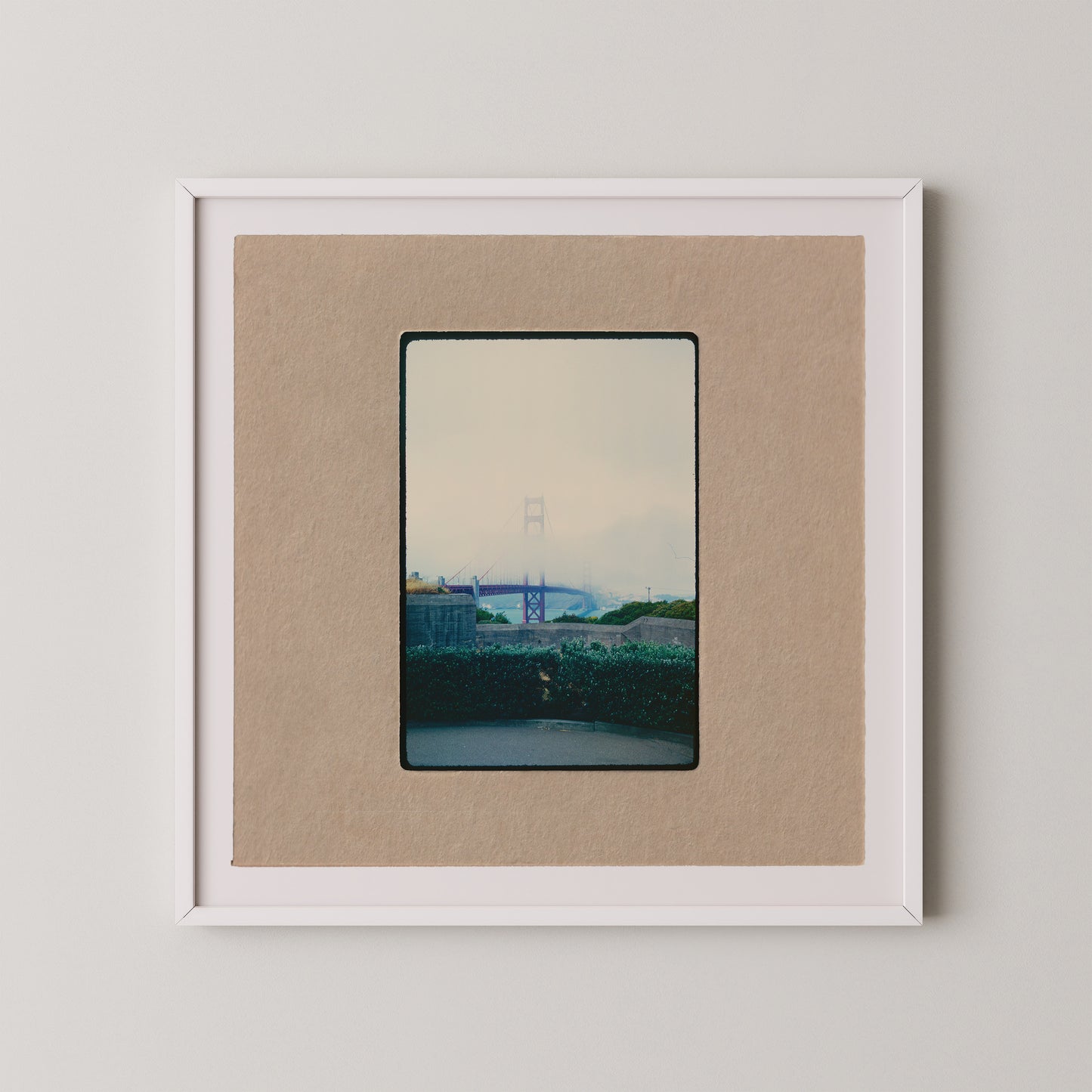 The image is a framed photograph of a bridge, with a cloudy sky in the background.