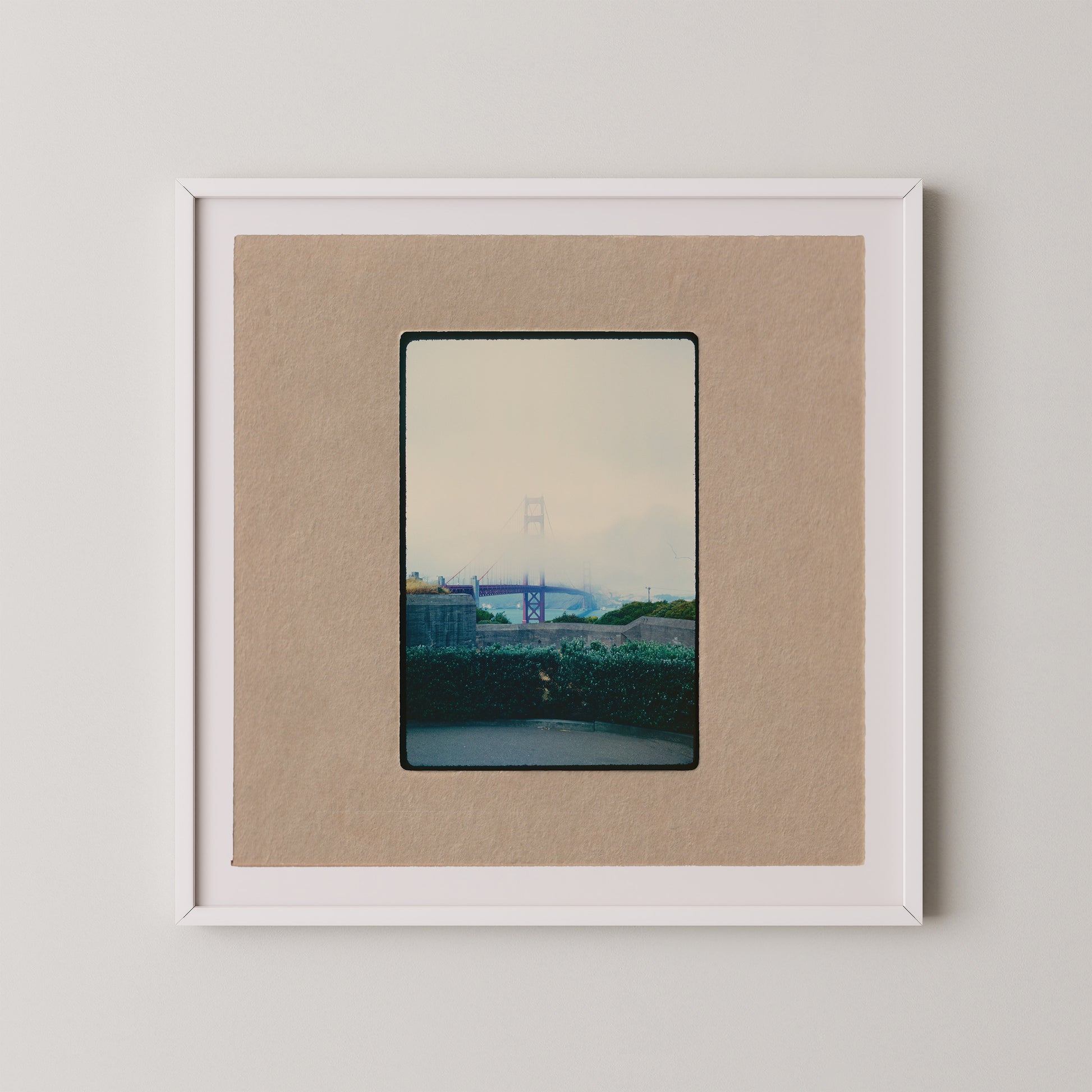 The image is a framed photograph of a bridge, with a cloudy sky in the background.
