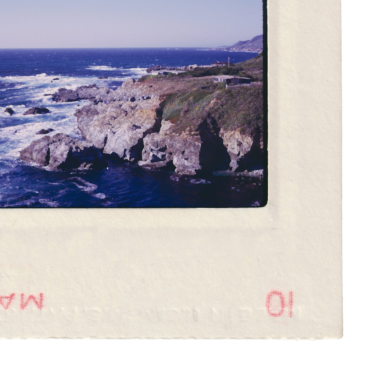 a rocky coastline with crashing waves, a lighthouse, and a small village in the distance.