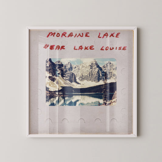 The image is a framed photograph of a scenic mountain landscape, with the text "MORaine Lake" and "EAR Lake Louise" written above it.