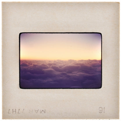 a beautiful sunset over a cloudy sky, with the sun setting behind the clouds.