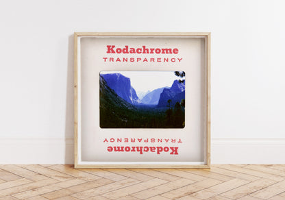 The image is a framed photograph of a mountainous landscape, with the text "Kodachrome Transparent" and "Kodachrome Transparent" repeated in the frame.