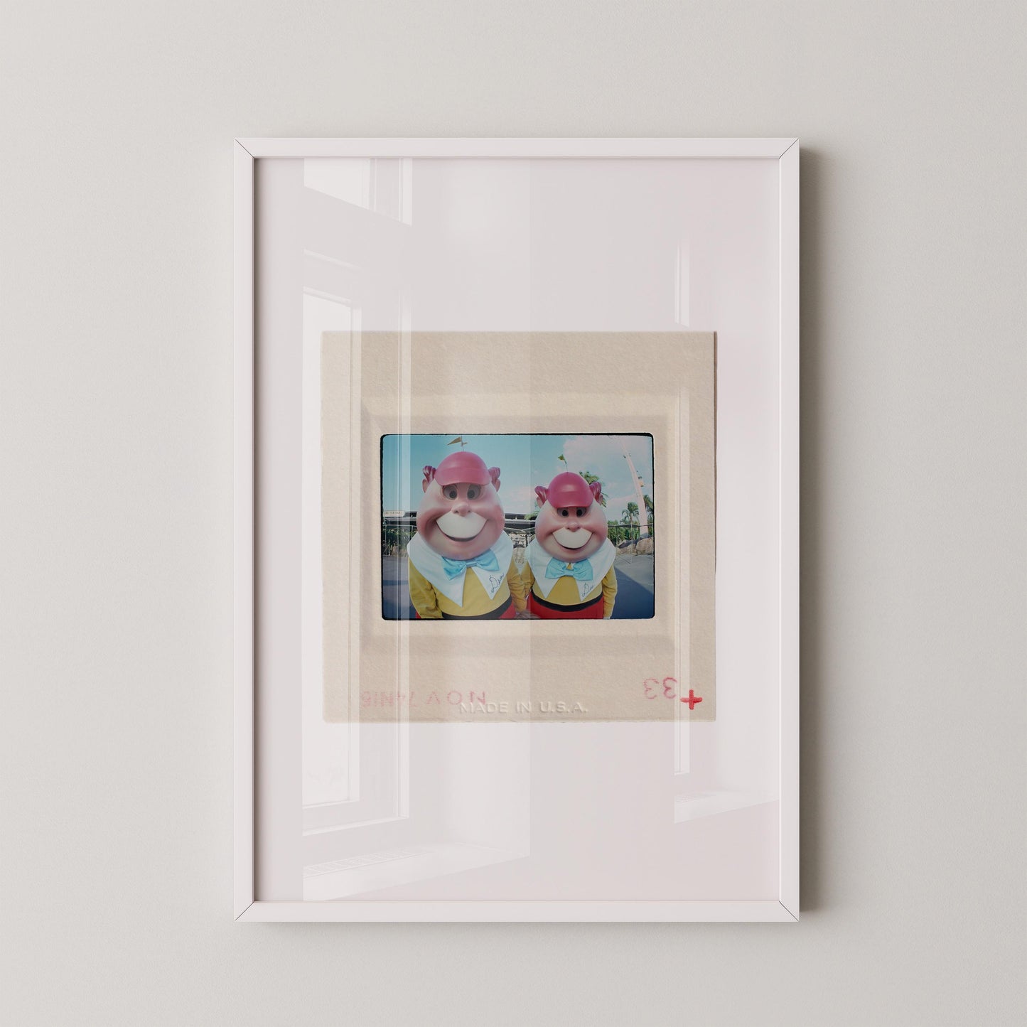 two cartoon characters wearing colorful outfits and hats, standing together in a frame.