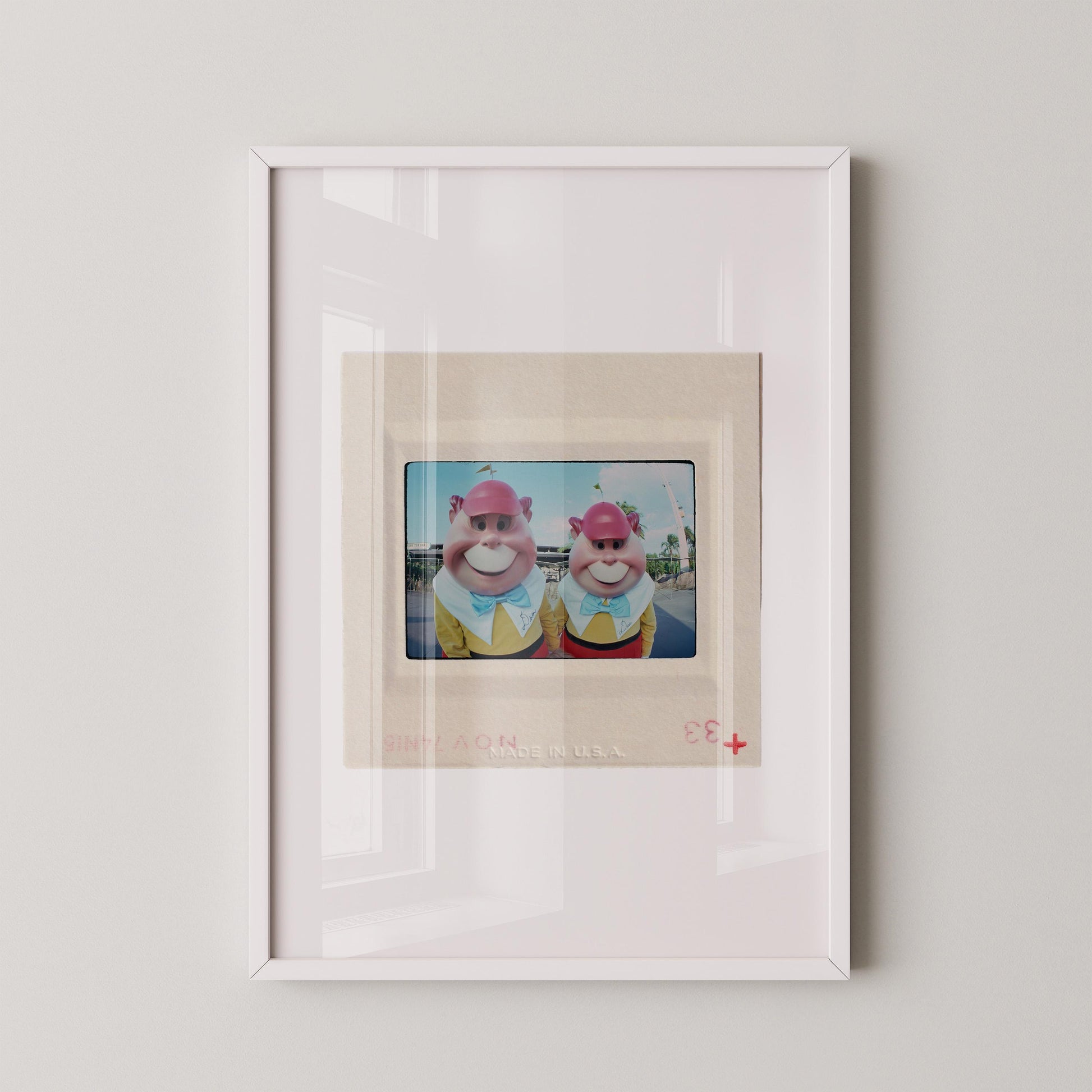 two cartoon characters wearing colorful outfits and hats, standing together in a frame.