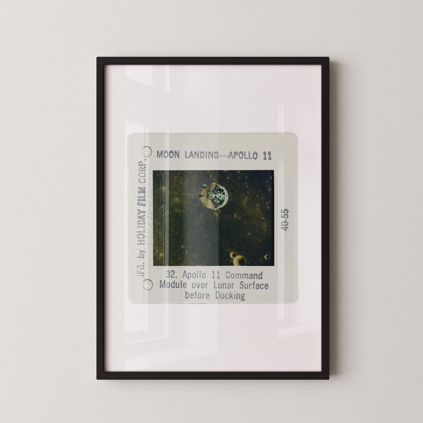 The image is a framed photograph of a space shuttle landing on the moon, specifically Apollo 11.