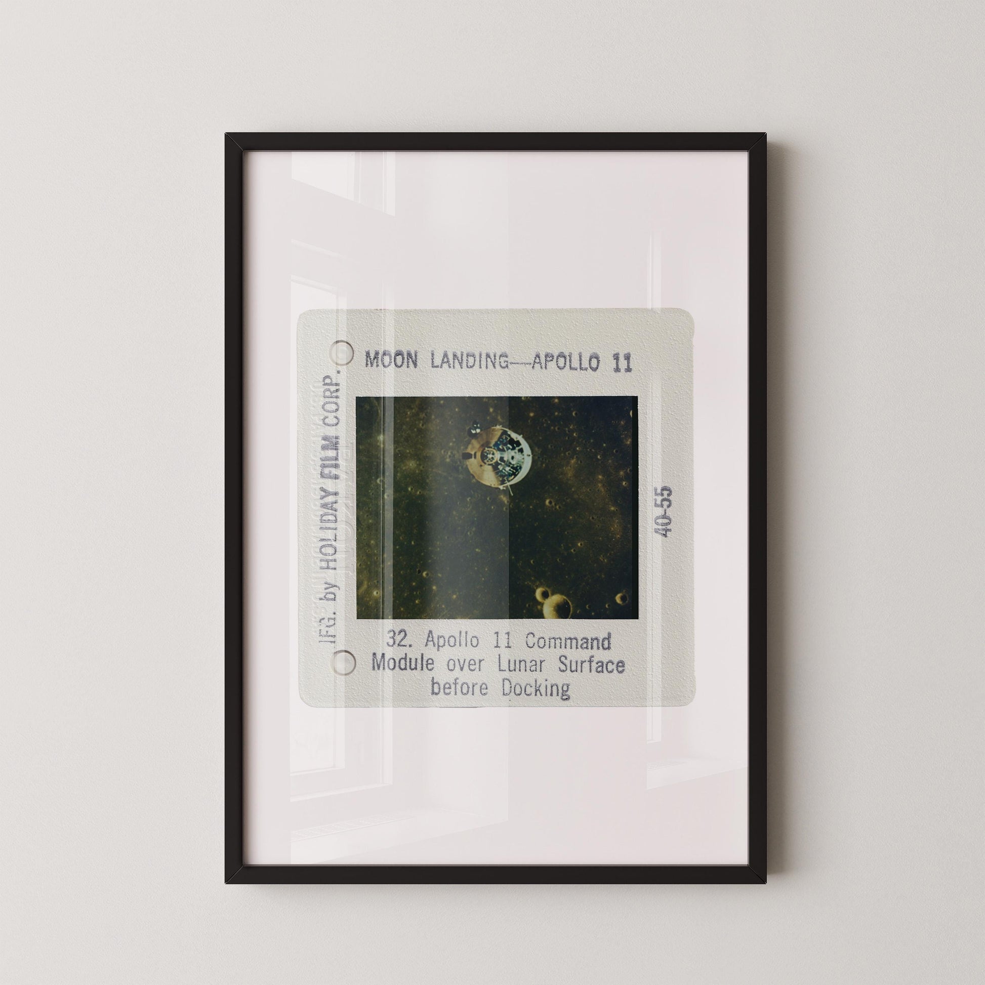 The image is a framed photograph of a space shuttle landing on the moon, specifically Apollo 11.