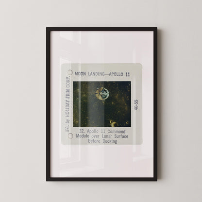 The image is a framed photograph of a space shuttle landing on the moon, specifically Apollo 11.