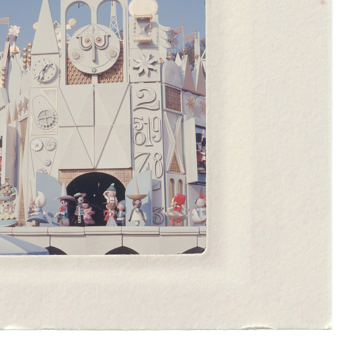 a miniature model of a clock tower with various small figures and decorations, including a clock and other architectural elements.