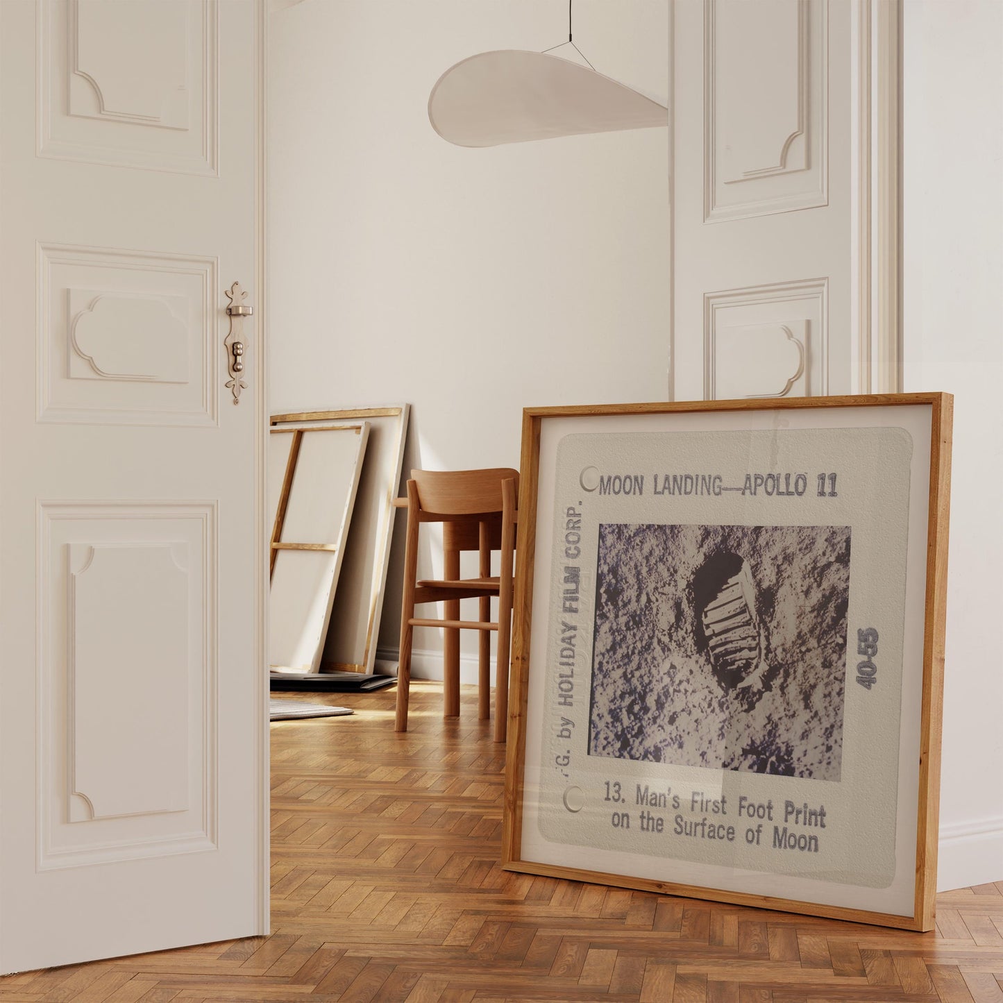 a framed photograph of the Apollo 11 moon landing, with the text "Moon Landing—Apollo 11" and "13. Man's First Foot Print on the Surface of Moon" visible.