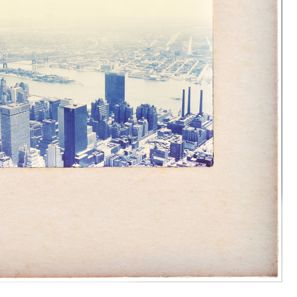The image is a panoramic view of a large city, likely New York, with numerous tall buildings and skyscrapers. The cityscape is captured from a high vantage point, providing a comprehensive view of the urban landscape.