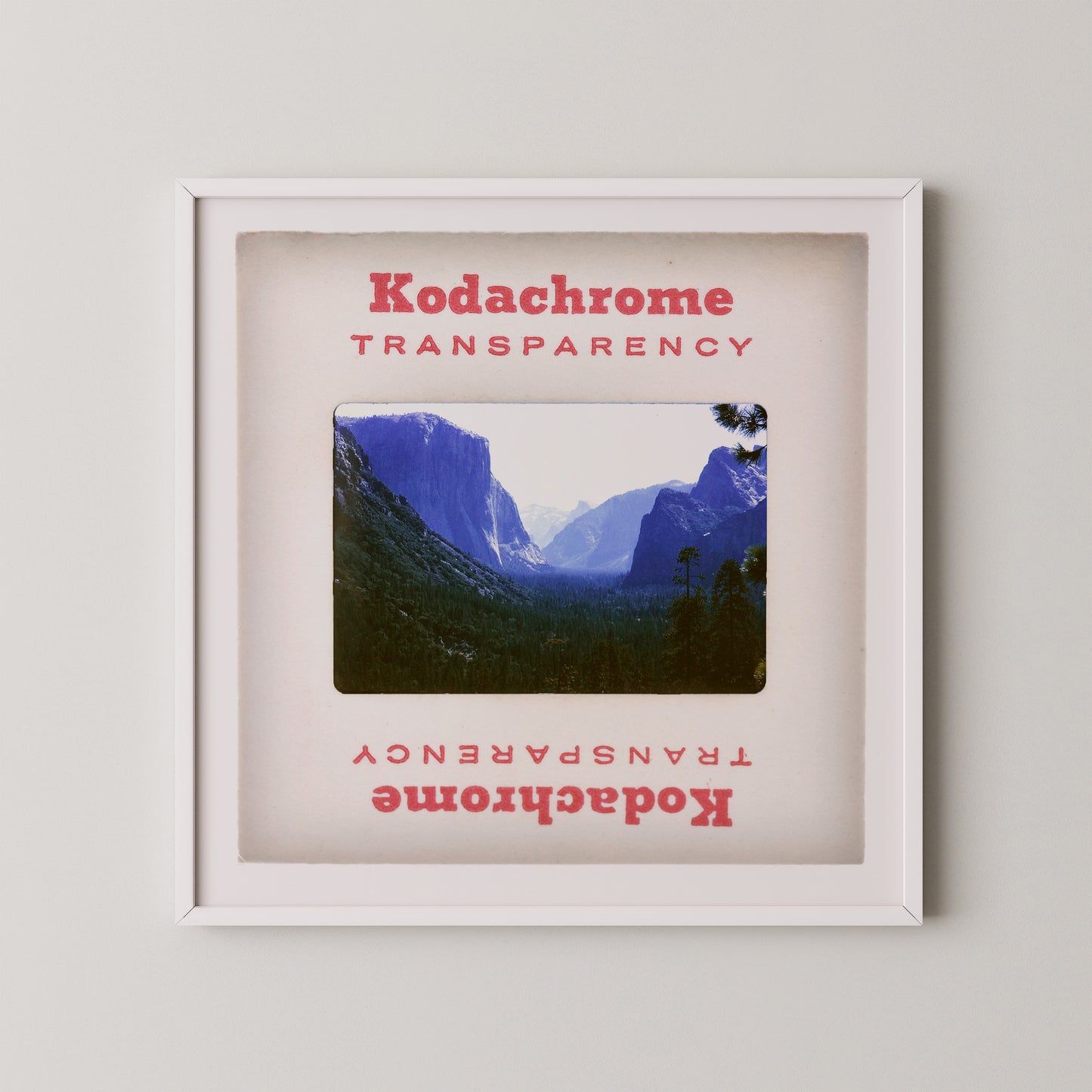 The image is a framed photograph of a mountainous landscape, with the text "Kodachrome Transparent" and "Kodachrome Transparent" repeated in the frame.