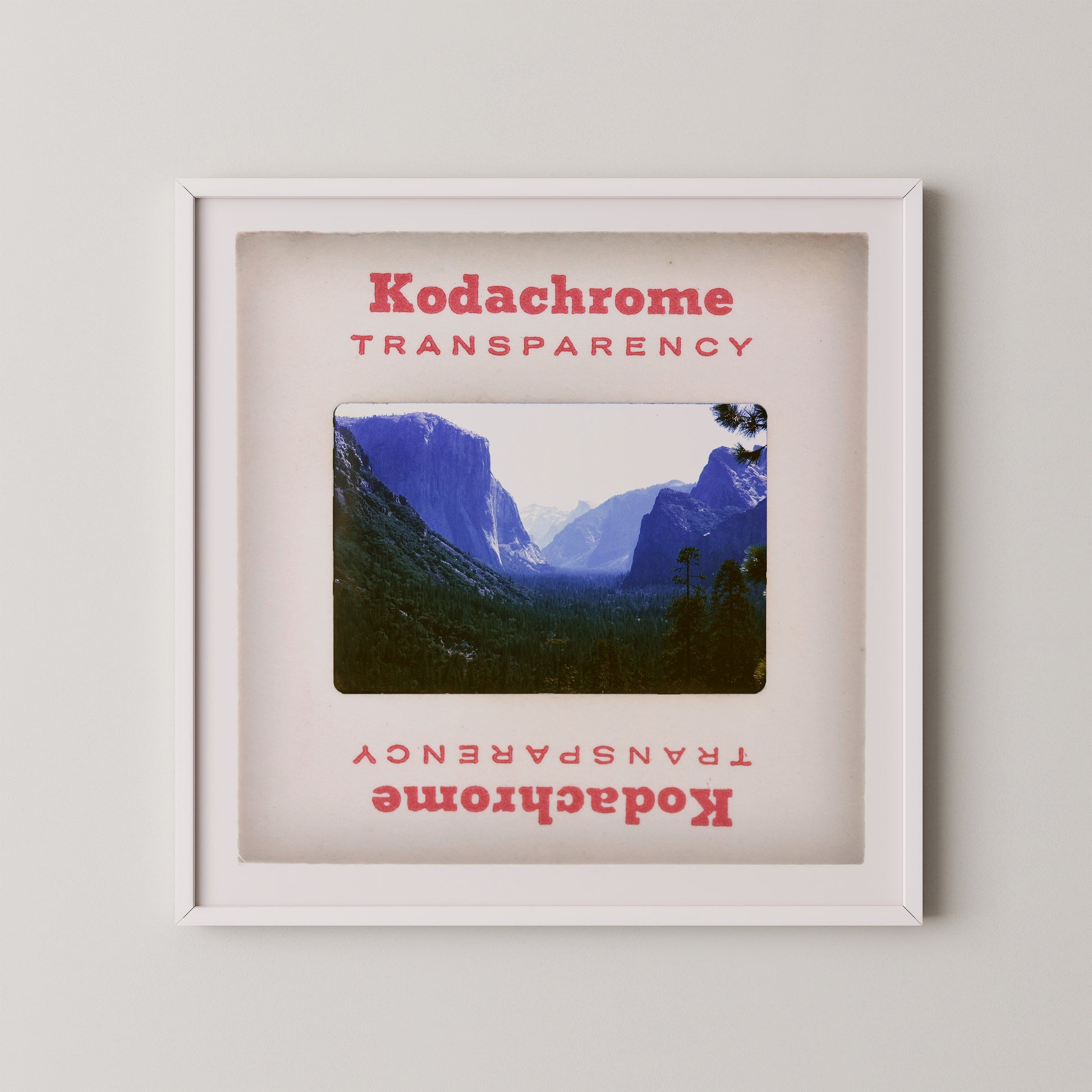 The image is a framed photograph of a mountainous landscape, with the text "Kodachrome Transparent" and "Kodachrome Transparent" repeated in the frame.