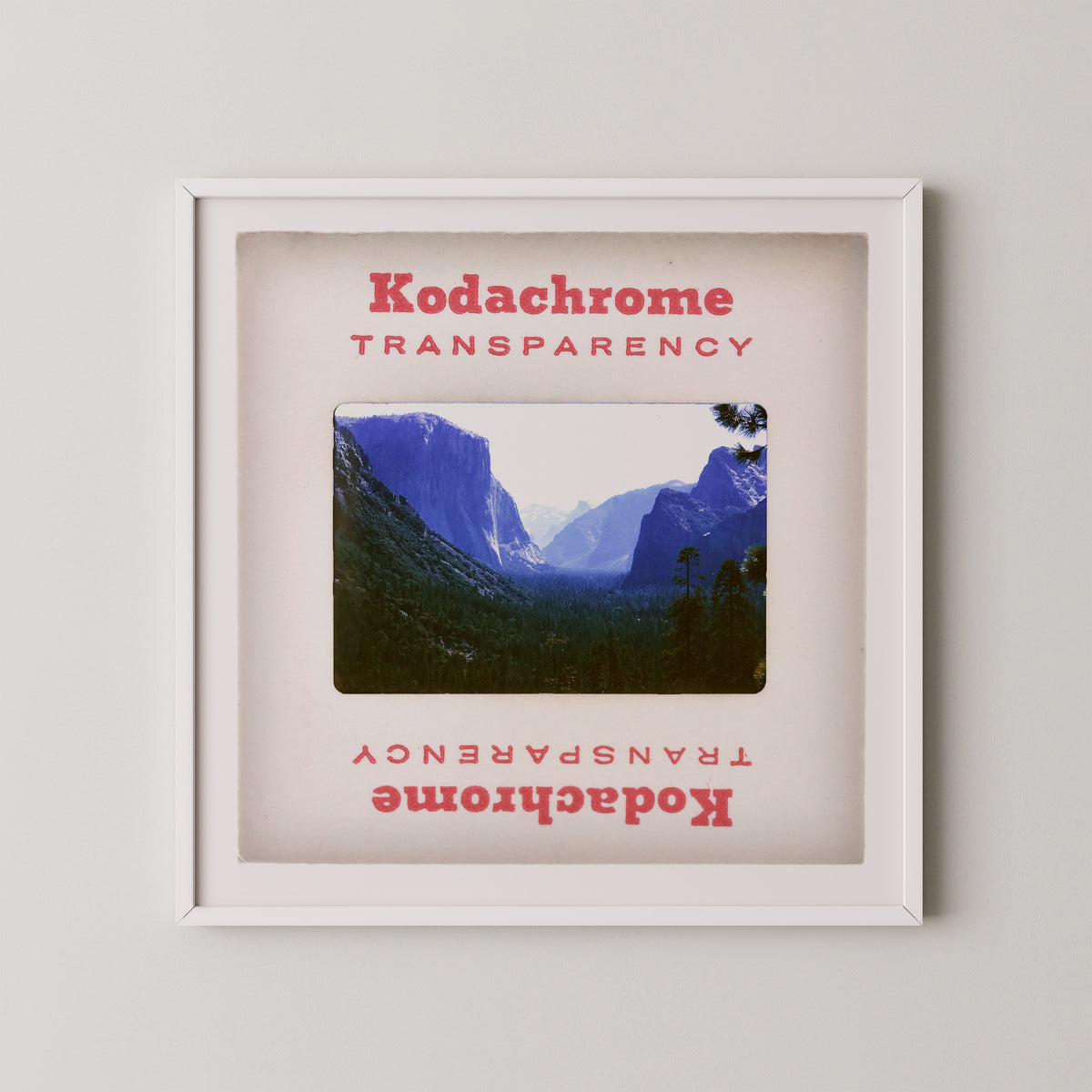 The image is a framed photograph of a mountainous landscape, with the text "Kodachrome Transparent" and "Kodachrome Transparent" repeated in the frame.