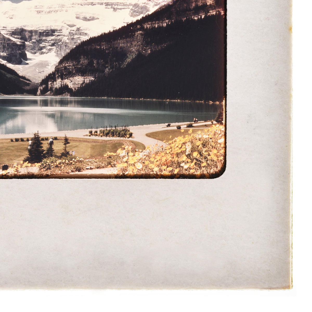 A scenic landscape with a lake, mountains, and a small town in the distance.