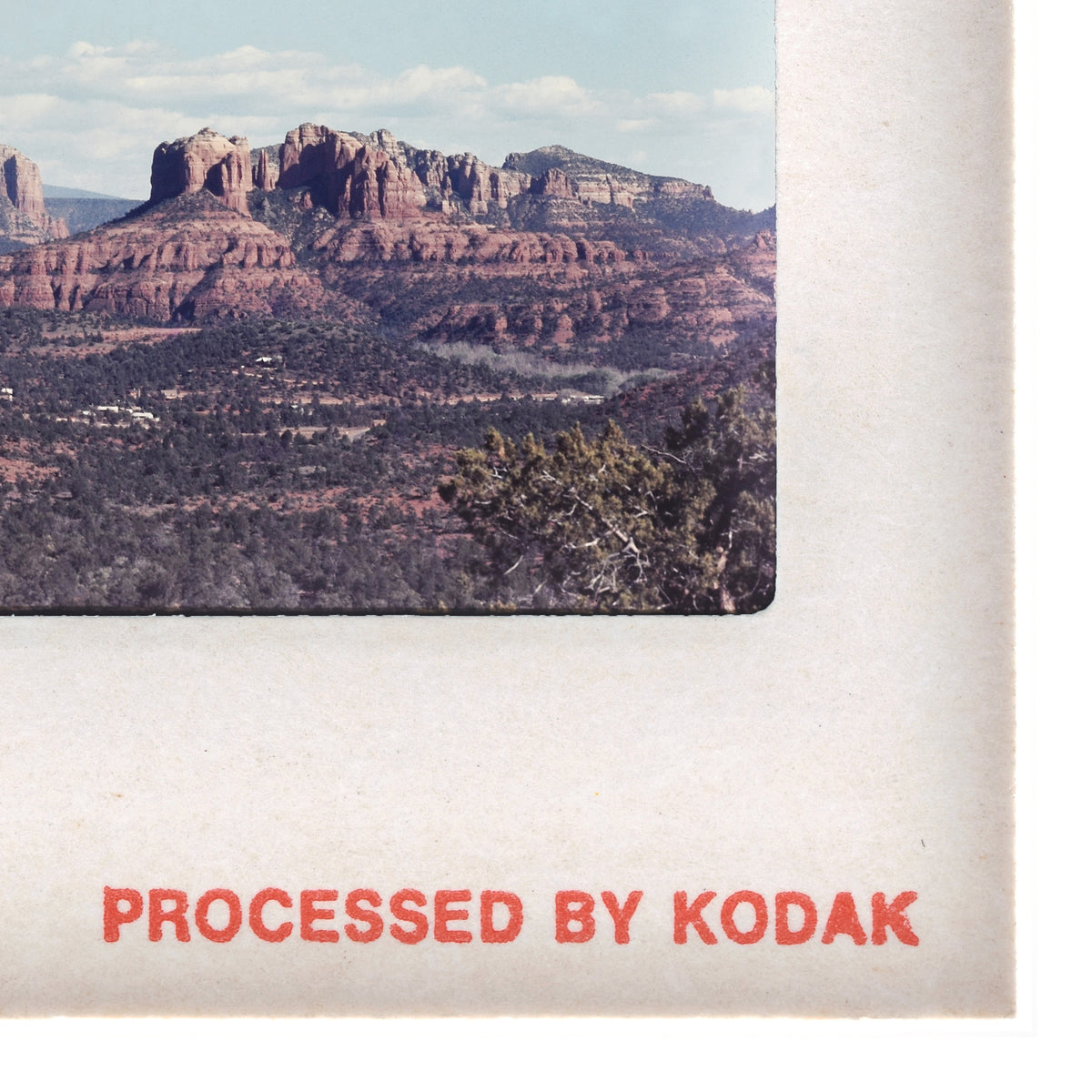 A framed photograph of a scenic desert landscape with mountains in the background.