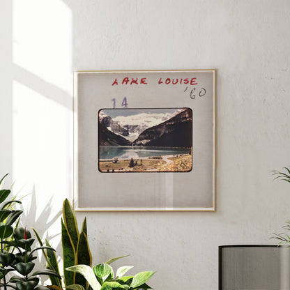 The image is a framed photograph of a scenic mountain landscape, with the name 'LARGE LOUISE' written above it.