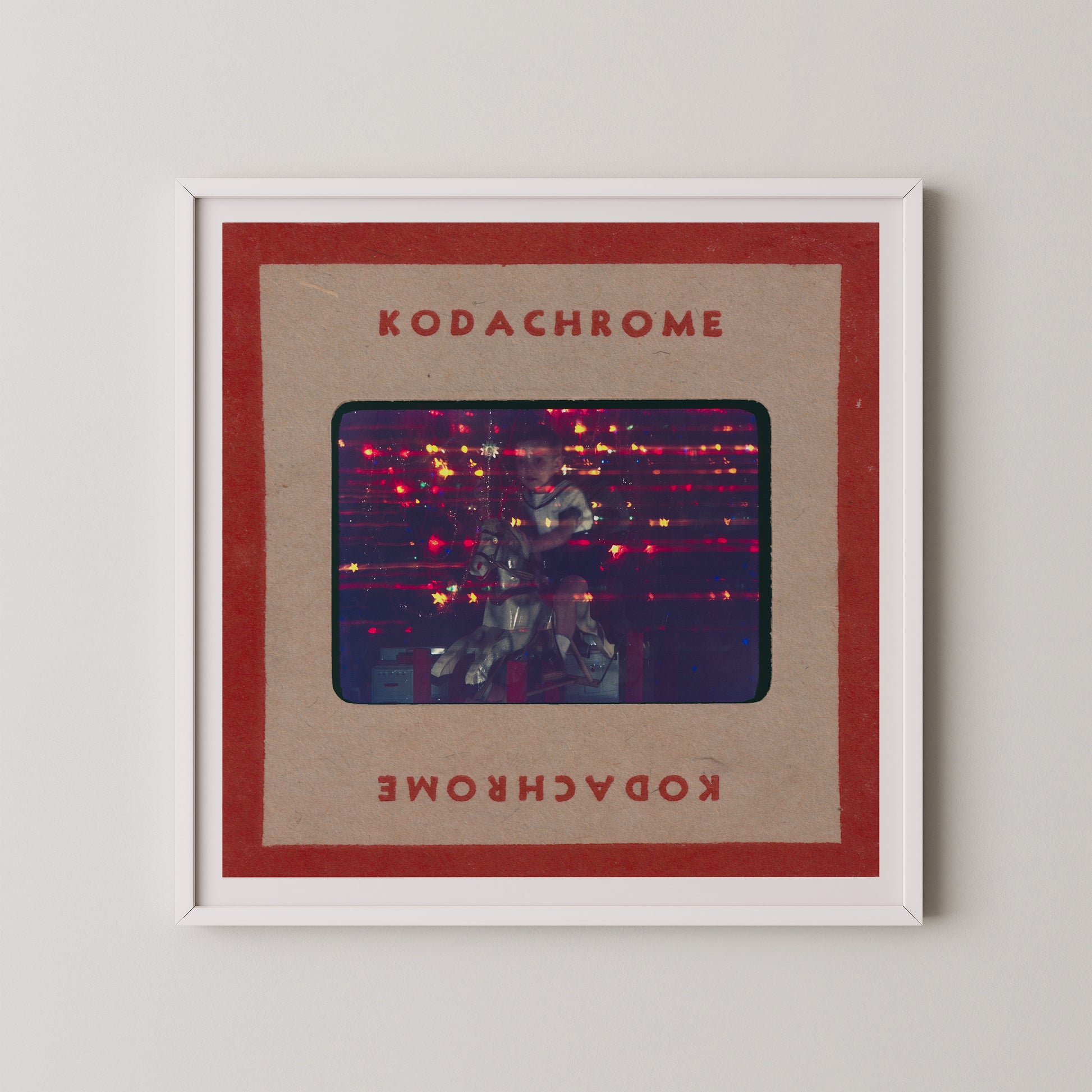 The image is a framed photograph of a person playing a guitar, with the text "KODACHrome" and "Kodachrome" written on the frame.
