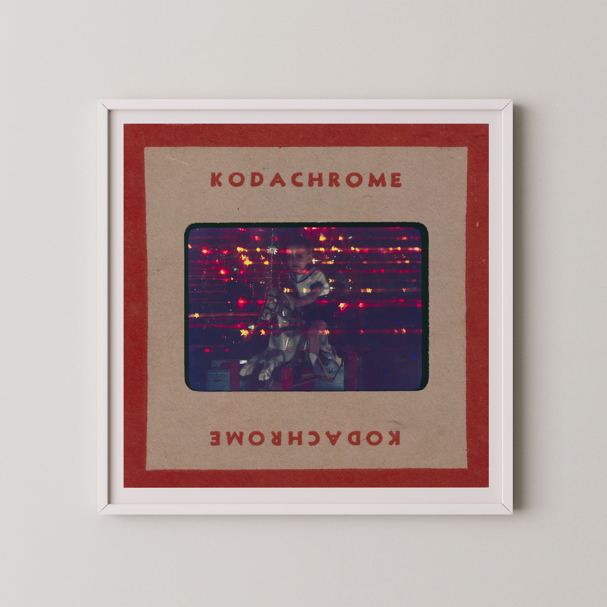 The image is a framed photograph of a person playing a guitar, with the text "KODACHrome" and "Kodachrome" written on the frame.