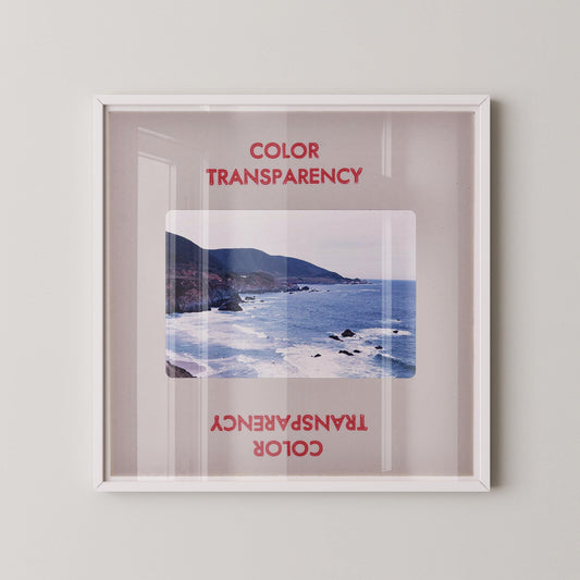 The image is a framed photograph of a coastal landscape, with the text "COLOR TRANSPARENCY" and "COLOR" visible in the frame.