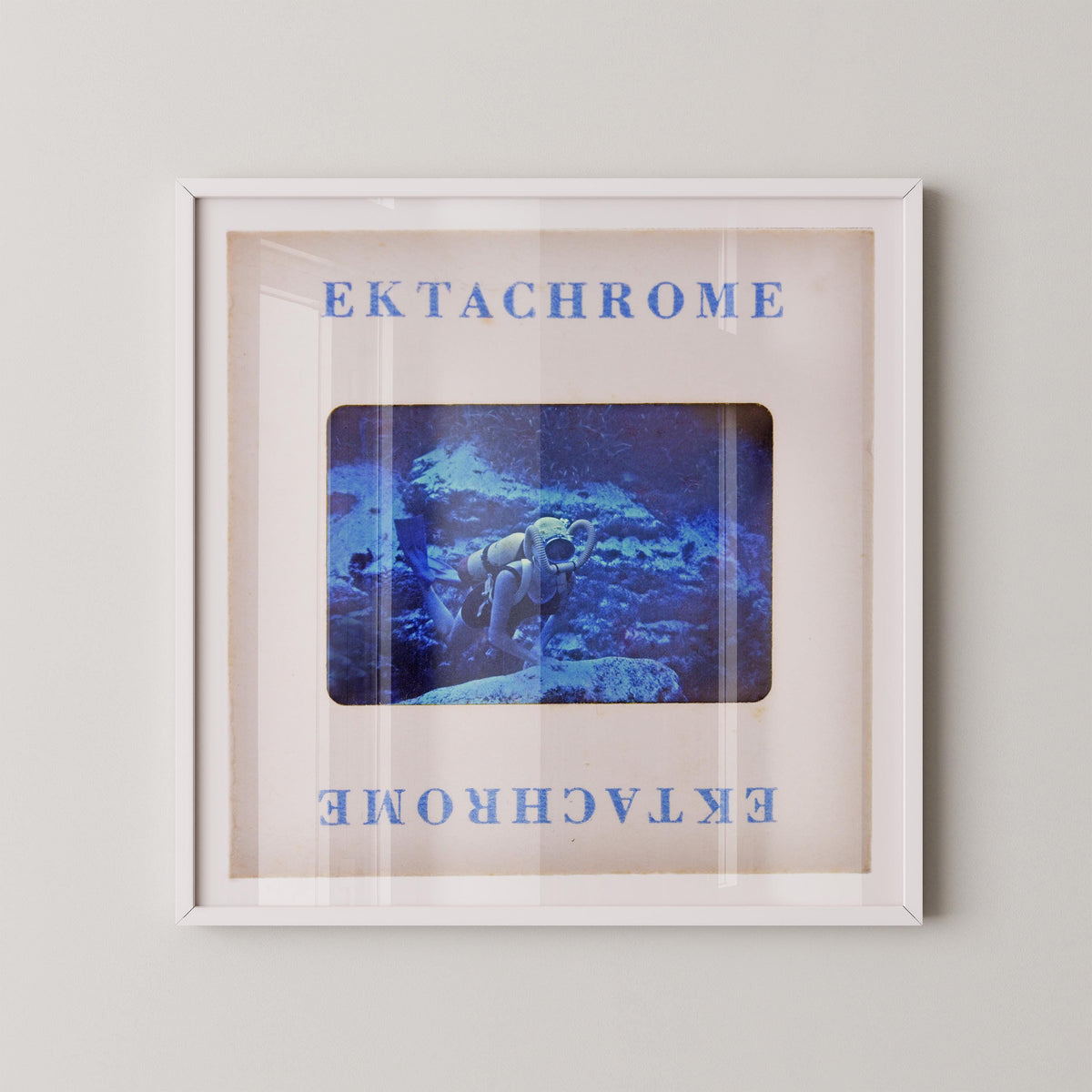 The image is a framed artwork depicting a person in a white suit standing in a blue underwater scene.