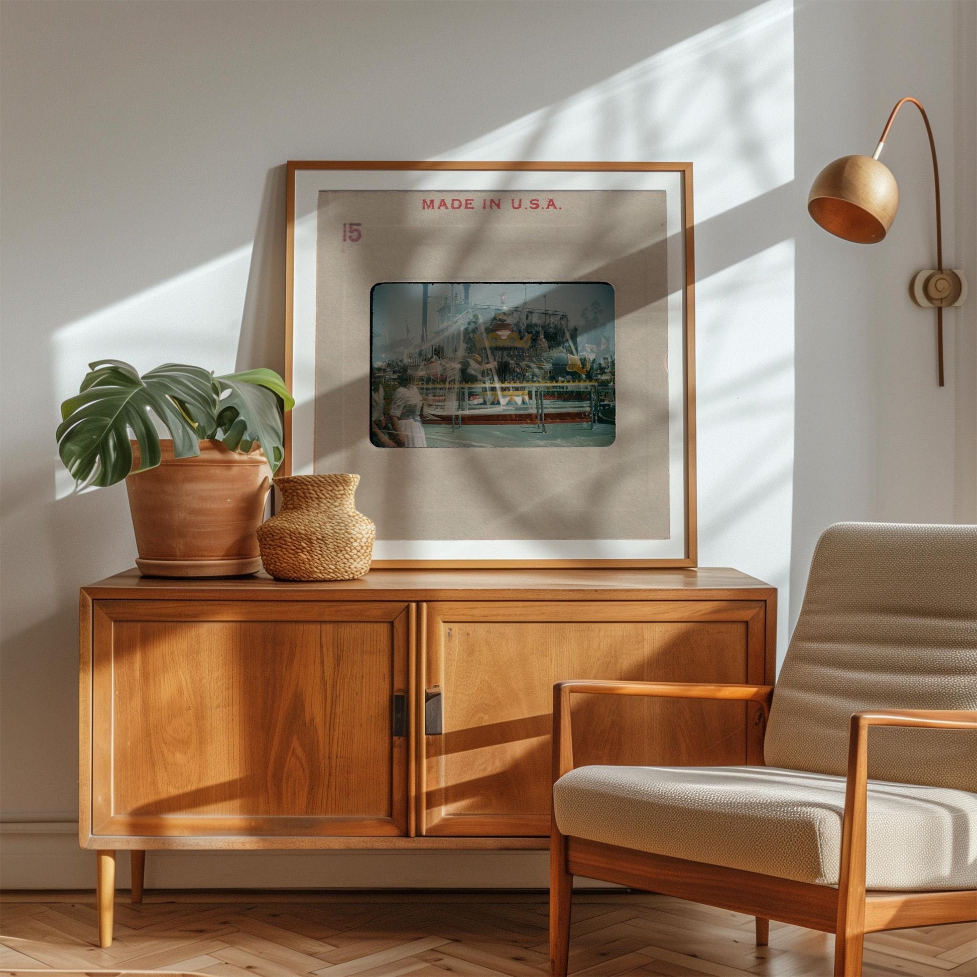 a wooden cabinet with a framed picture of a ship on top, a potted plant, and a woven basket on the cabinet. The cabinet is situated in a room with a chair and a lamp.